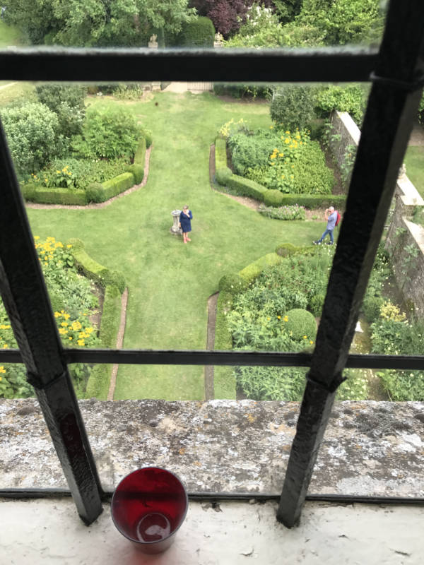 A garden view through a window at Newark Park
